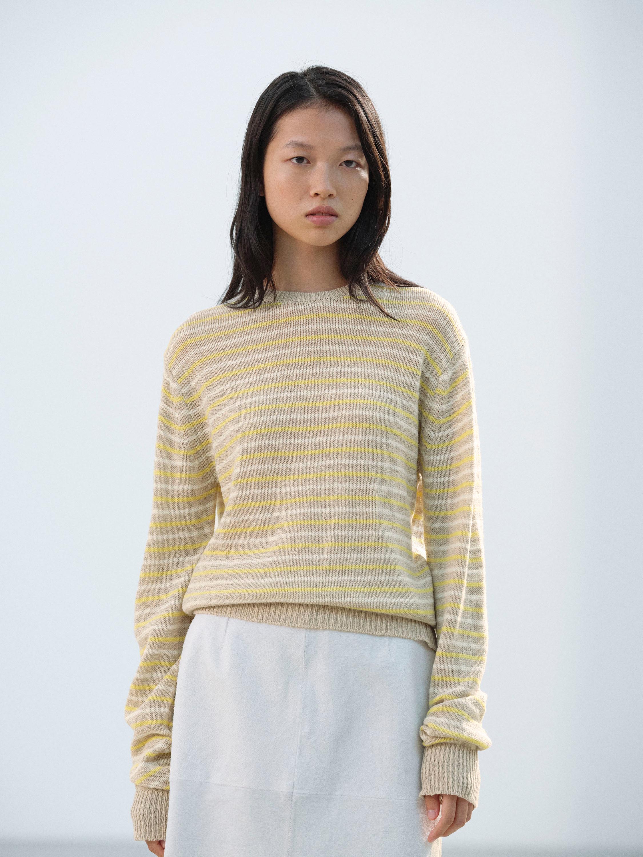 Asiatique cheveux mi-longs · Pull rayé jaune & beige · Jupe blanche